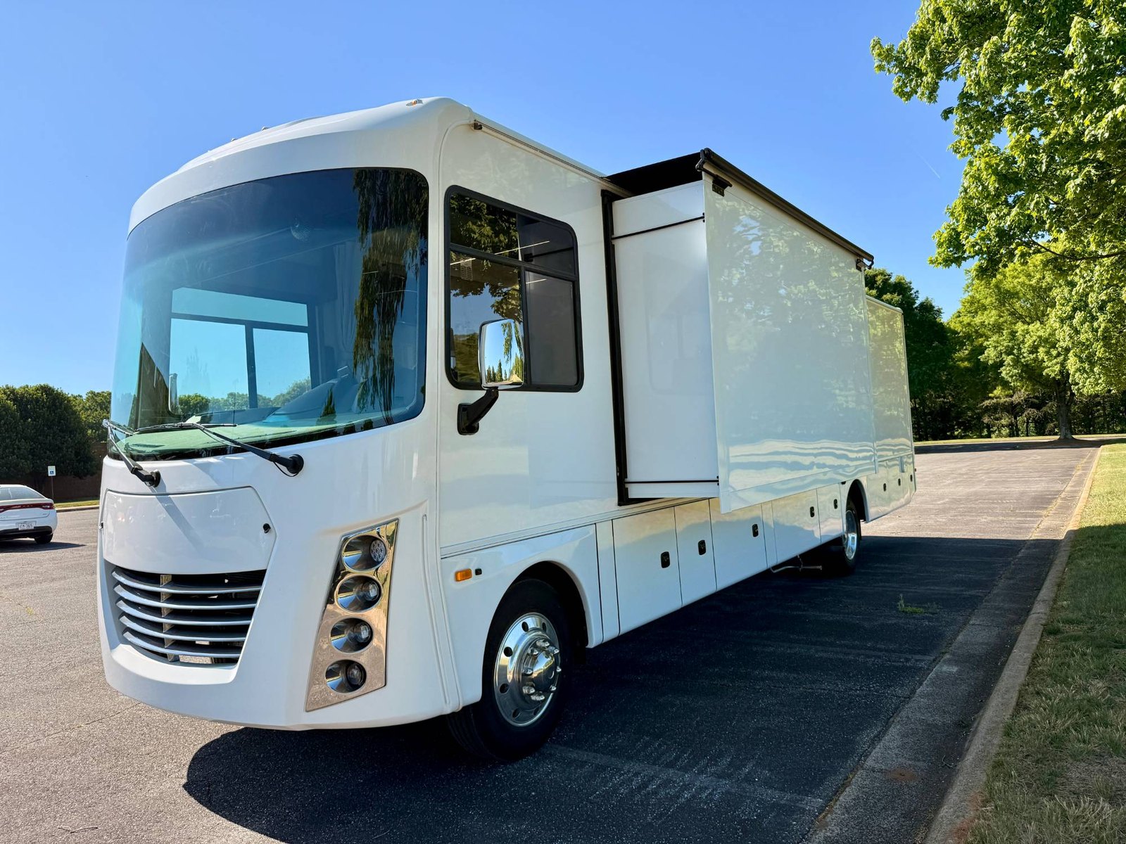 The XL Frontier mobile medical clinic with awning and slide-out extended, set up on site
